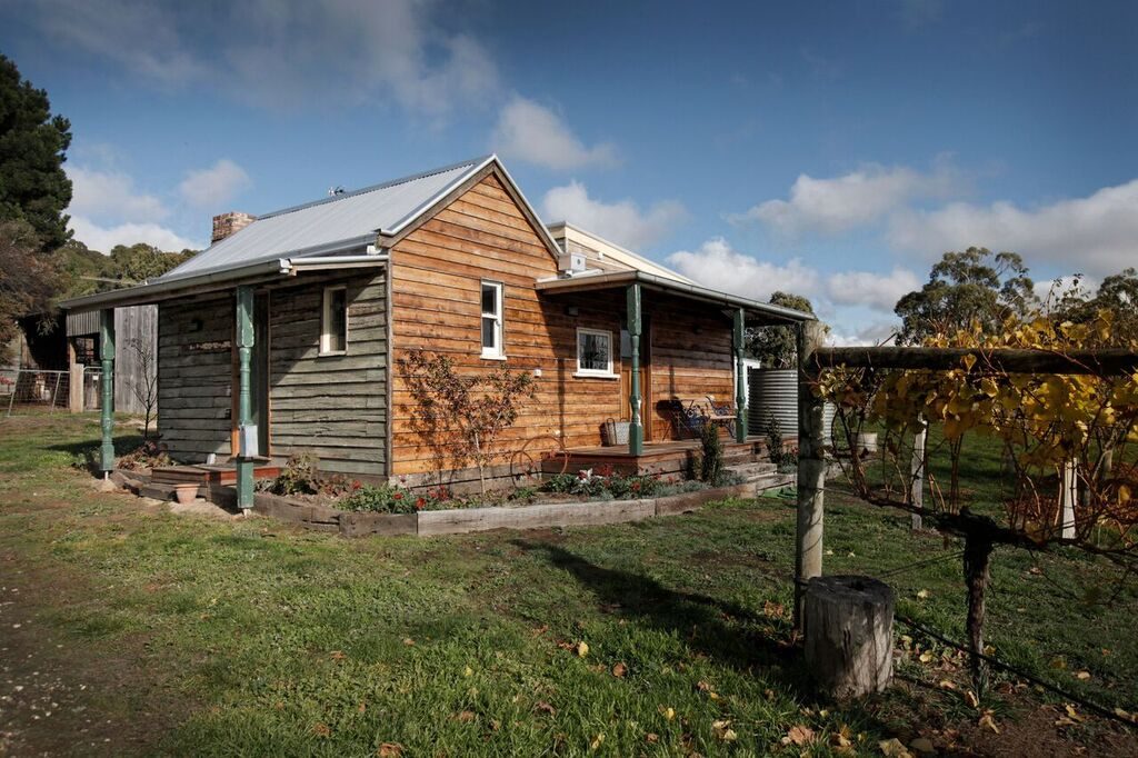 Spud Diggers Hut at Hesket Estate offers a rustic vineyard accommodation experience when visiting Hanging Rock.